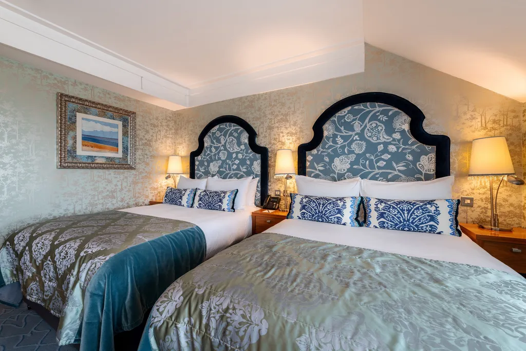 Larger Family Room with two beds and arched blue floral headboards