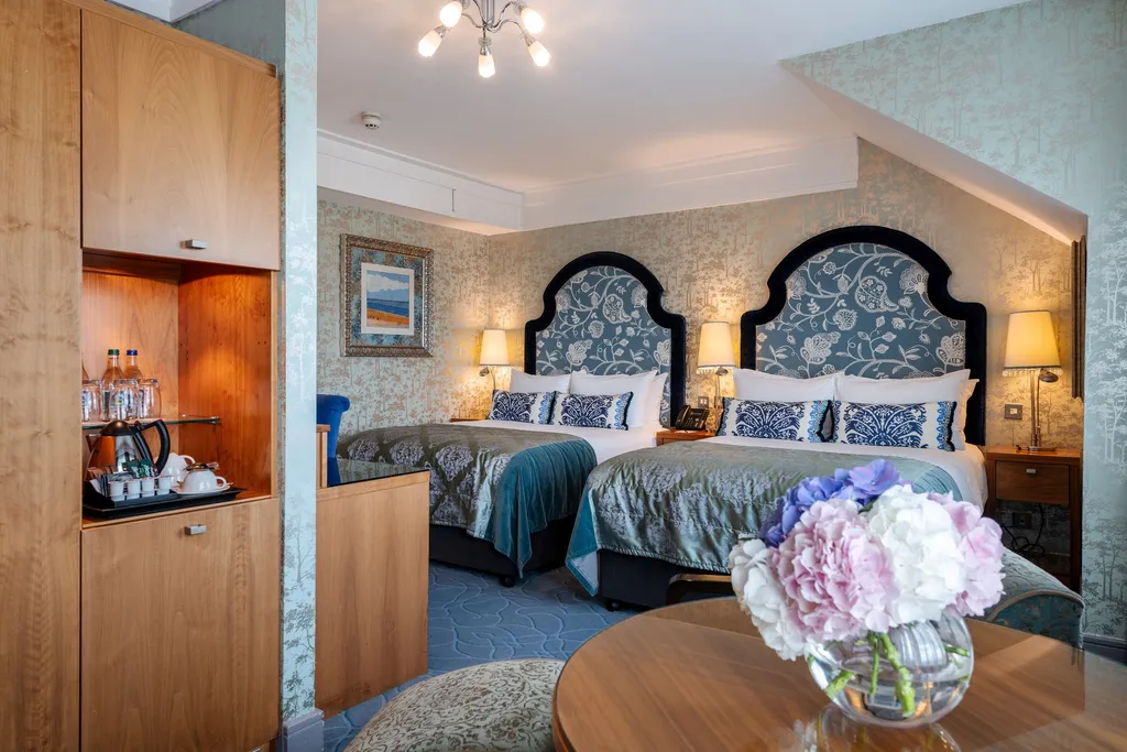 Larger Family Room with arched blue floral headboards, a tea station and hydrangeas