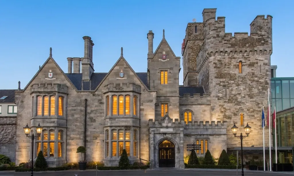 Clontarf Castle’s stone facade glowing at dusk
