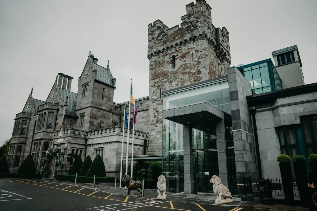 Castle entrance and stone lions beneath a grey sky
