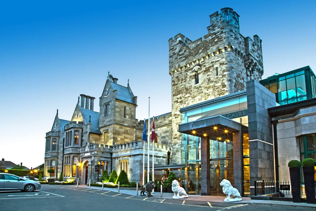 Castle entrance, lions and glass canopy at blue hour