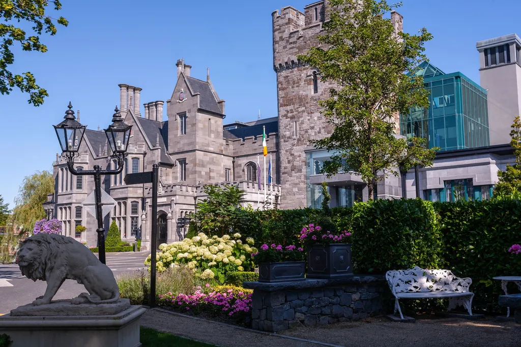 A stone lion and lamp posts before the castle