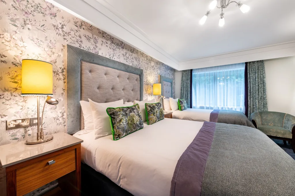 Family Room with a double and single bed, grey tufted headboards and green patterned cushions