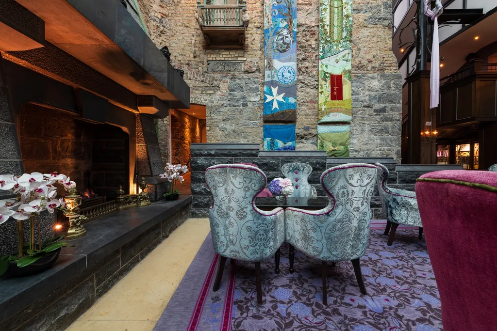 The lit lobby fireplace with orchids along the hearth