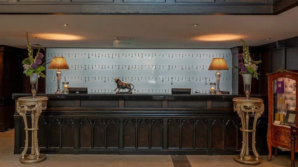 Reception desk with a wall of antique keys and a bronze bull