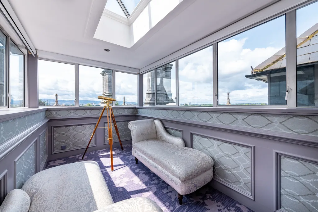Royal Suite glass-walled turret room with a chaise longue, brass telescope and views across Dublin