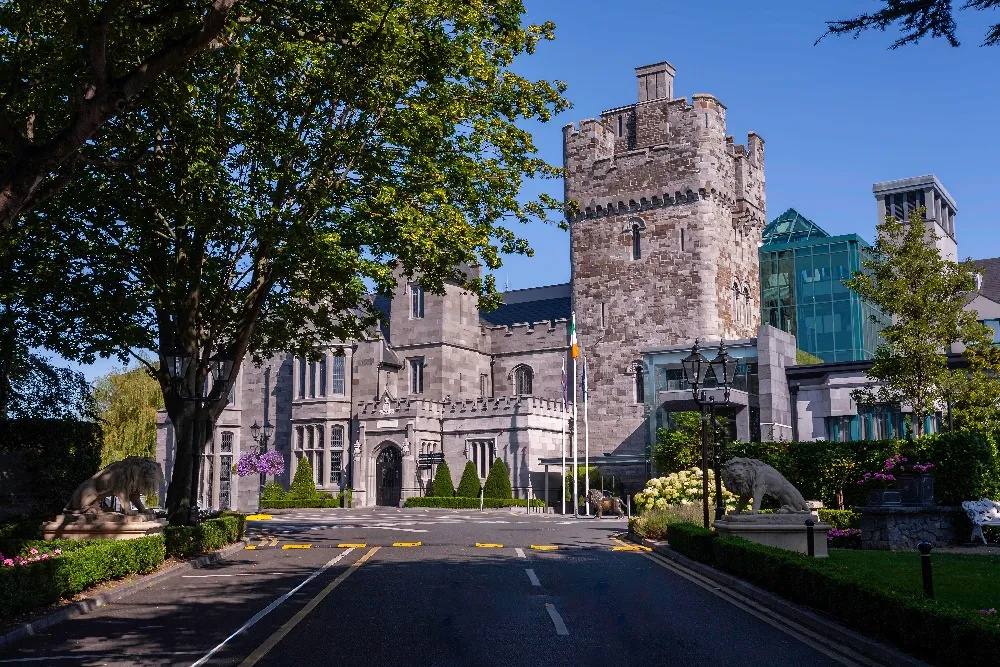 Clontarf Castle Hotel’s tower and entrance drive on a sunny day