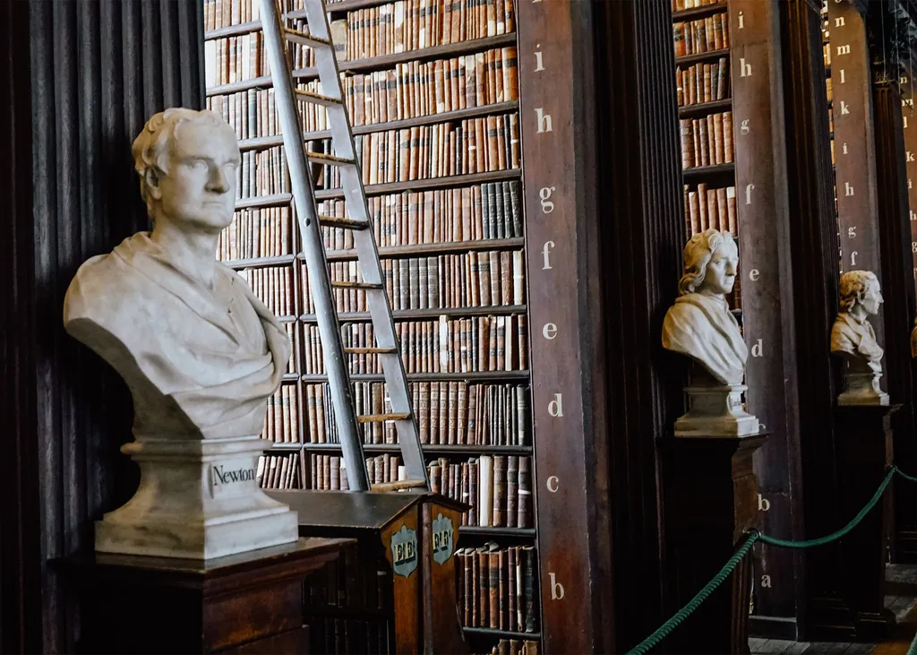 Marble busts and tall shelves of old books in the Long Room